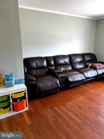 a view of deck and lake with trees in the background