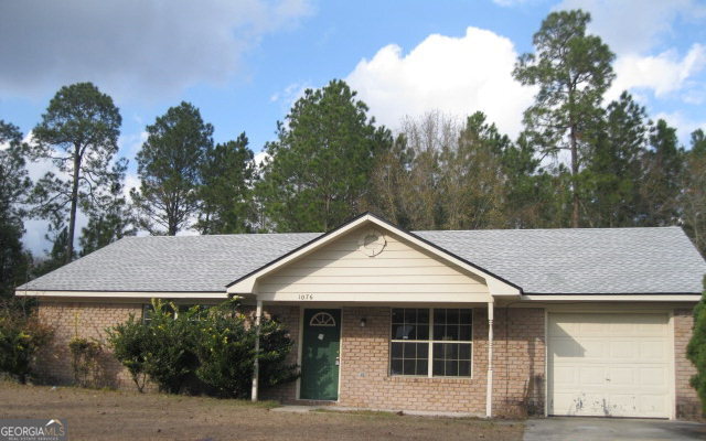 1076 Desert Shield Street Hinesville, GA 31313 - Photo 1 of 1 a view of a house with a yard and plants