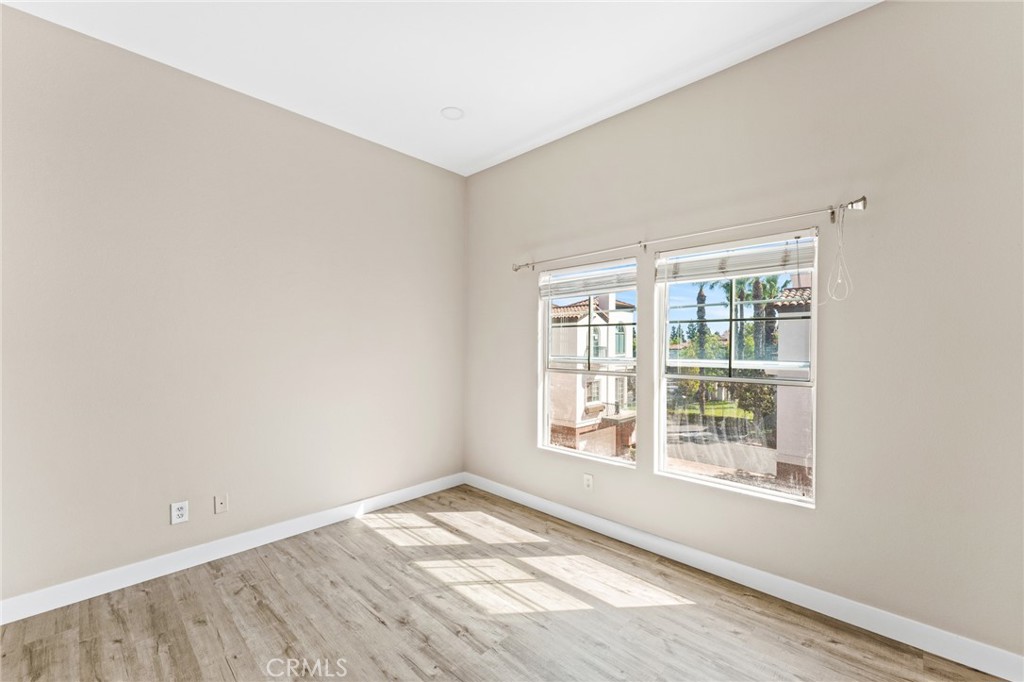2821 Player Lane Tustin, CA 92782 - Photo 15 of 18 an empty room with wooden floor and windows