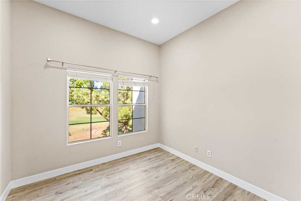 2821 Player Lane Tustin, CA 92782 - Photo 16 of 18 an empty room with wooden floor and windows