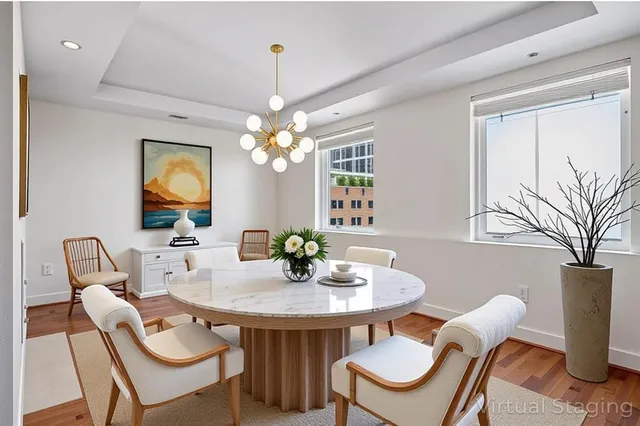 a view of a dining room with furniture and chandelier