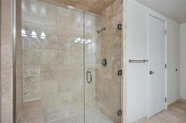 a bathroom with a glass shower door