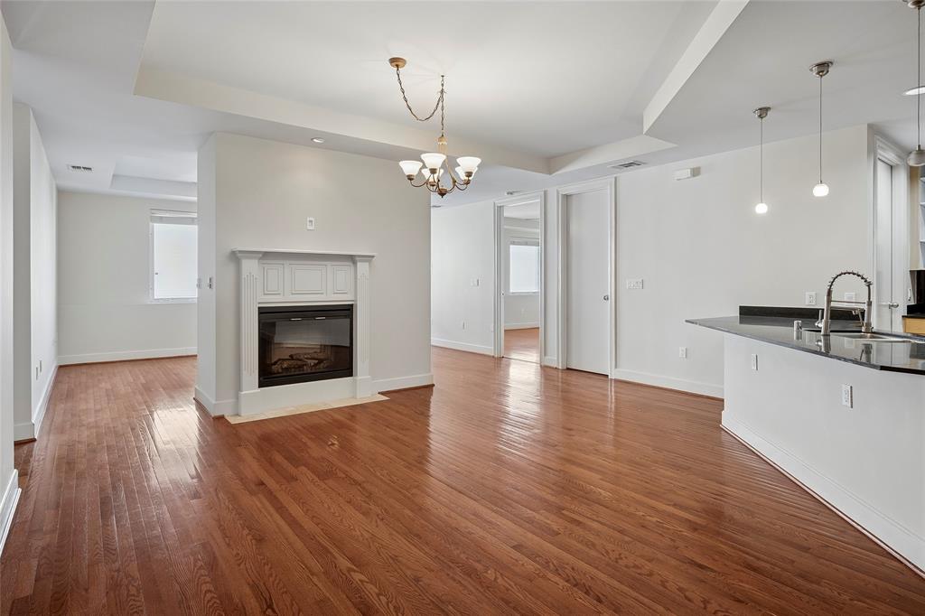 1505 Elm Street, Unit 603 Dallas, TX 75201 - Photo 2 of 36 a view of a room with wooden floor and a fireplace