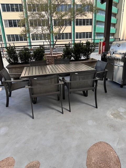1505 Elm Street, Unit 603 Dallas, TX 75201 - Photo 27 of 36 a view of a patio with a table and chairs