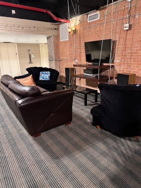 1505 Elm Street, Unit 603 Dallas, TX 75201 - Photo 31 of 36 a living room with a couch and a flat screen tv