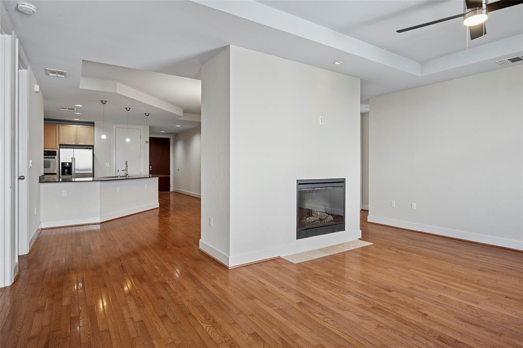1505 Elm Street, Unit 603 Dallas, TX 75201 - Photo 4 of 36 a view of a big room with wooden floor and a kitchen