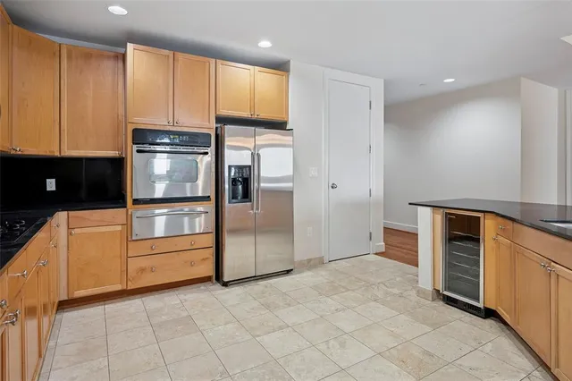 a kitchen with white cabinets and refrigerator