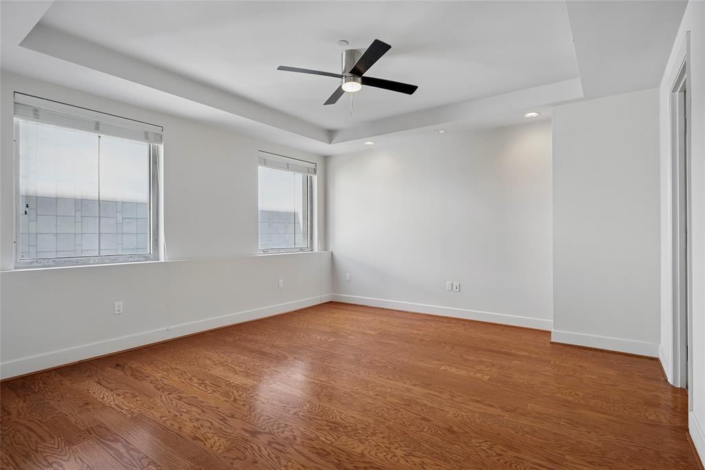 1505 Elm Street, Unit 603 Dallas, TX 75201 - Photo 10 of 36 wooden floor in an empty room with a window