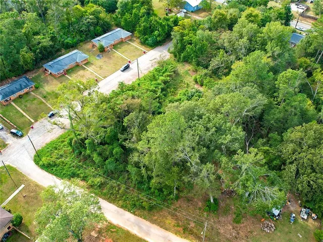 a aerial view of a house with a yard and lake view