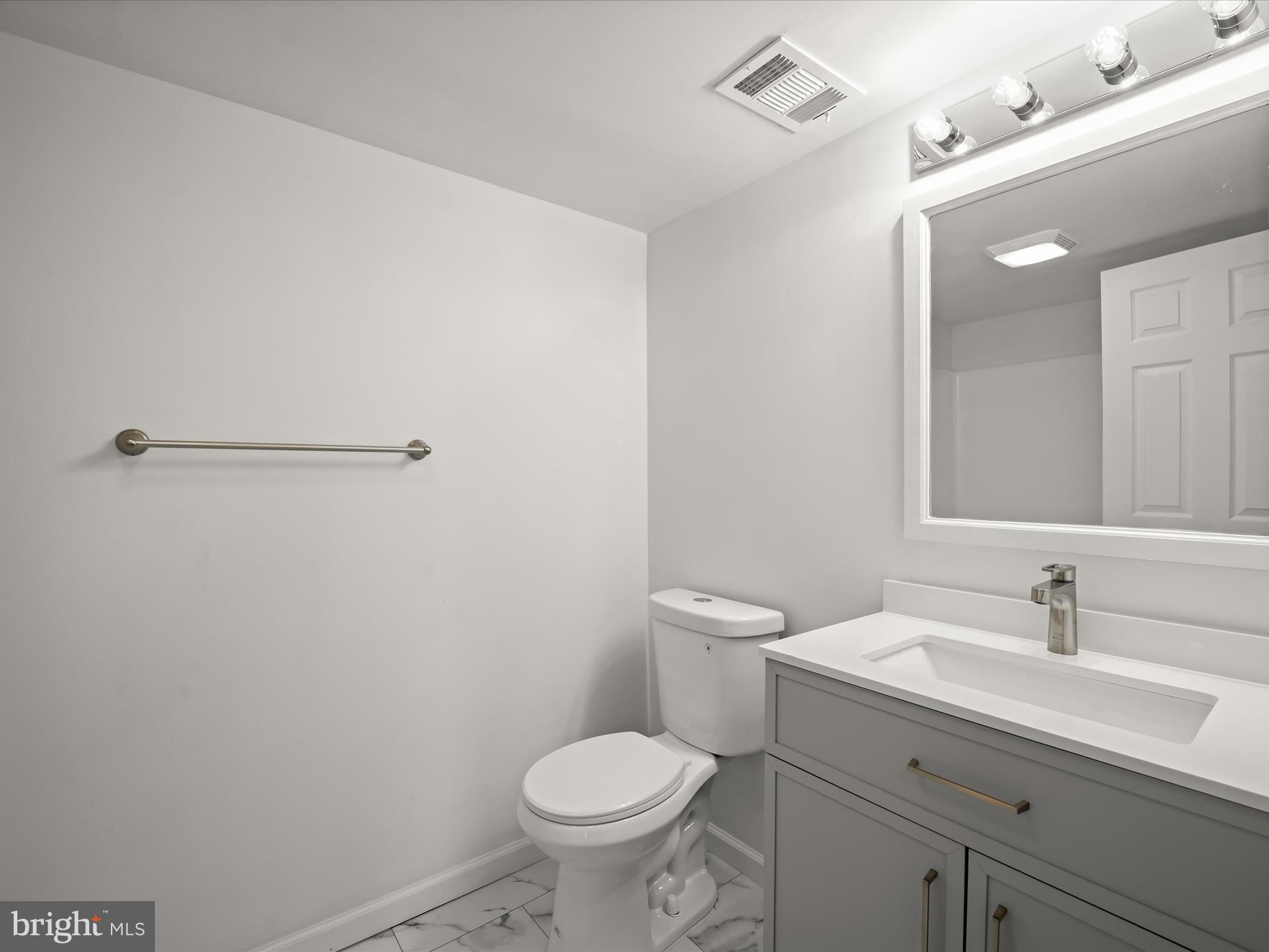 13303 Pendleton Street Fort Washington, MD 20744 - Photo 17 of 35 a bathroom with a sink toilet and a mirror