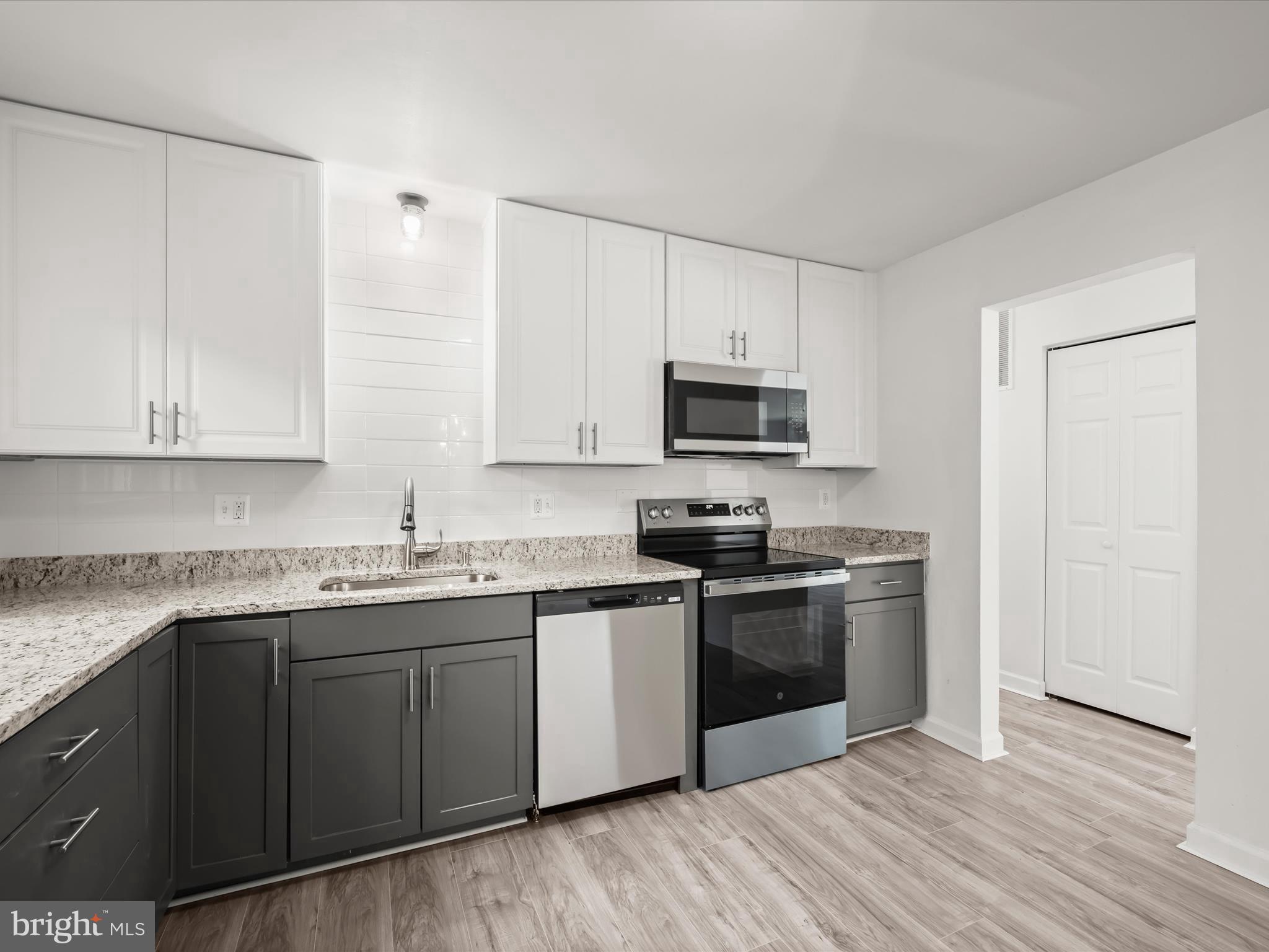 13303 Pendleton Street Fort Washington, MD 20744 - Photo 5 of 35 a kitchen with stainless steel appliances granite countertop a sink stove and refrigerator