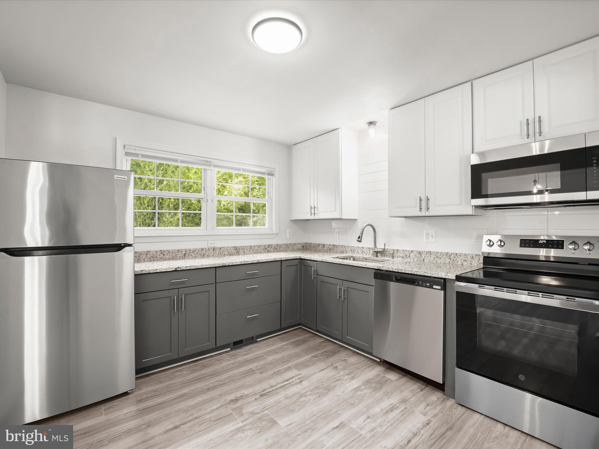 13303 Pendleton Street Fort Washington, MD 20744 - Photo 8 of 35 a kitchen with stainless steel appliances granite countertop a stove a sink and a refrigerator