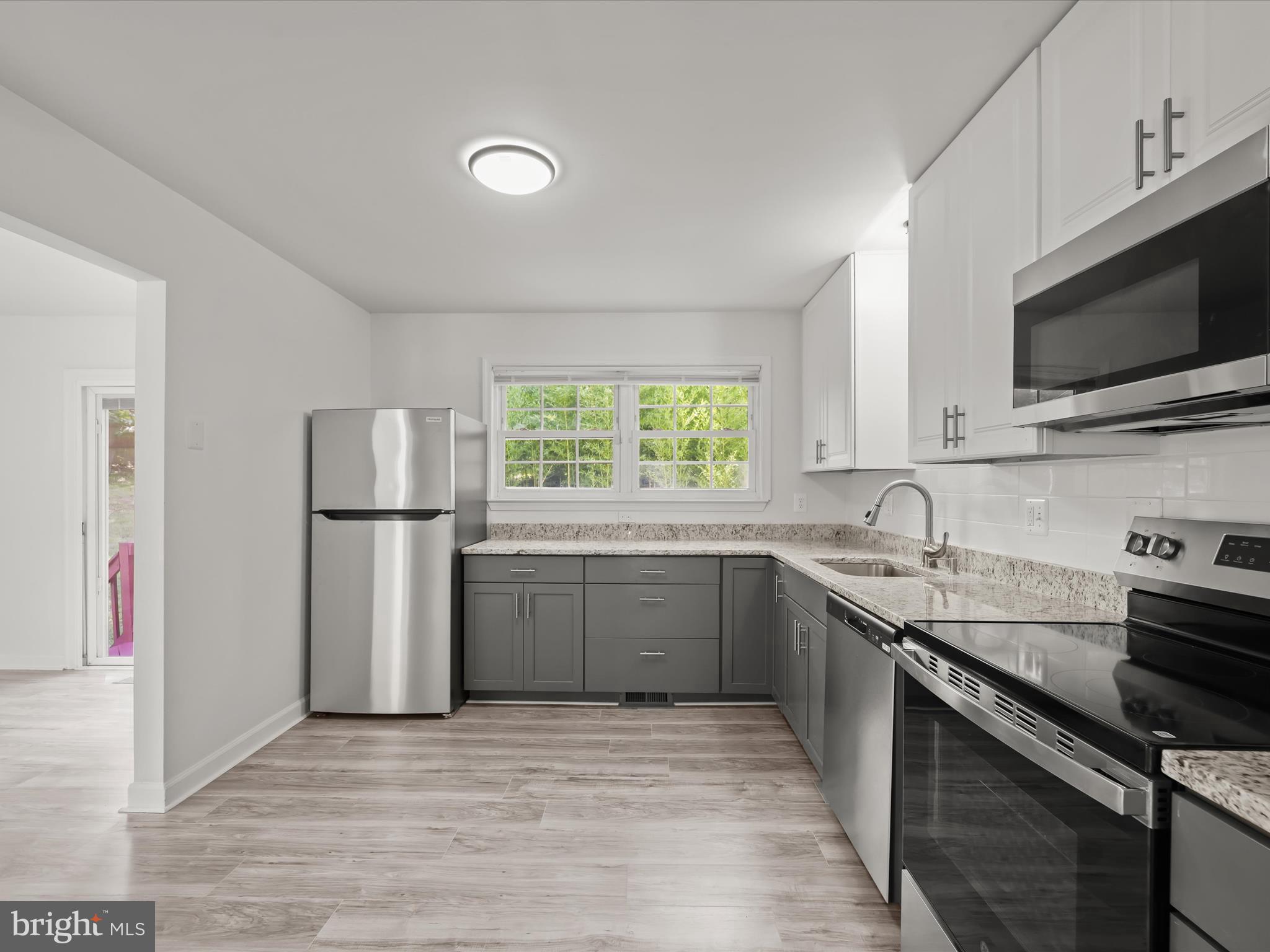 13303 Pendleton Street Fort Washington, MD 20744 - Photo 9 of 35 a kitchen with a sink a window and stainless steel appliances