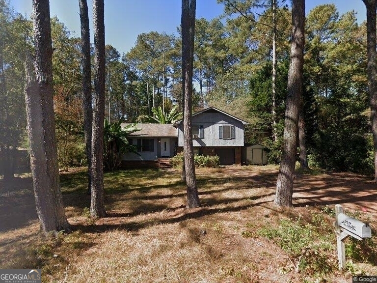3147 Goode Road Conyers, GA 30094 - Photo 1 of 1 a view of a house with backyard and a tree