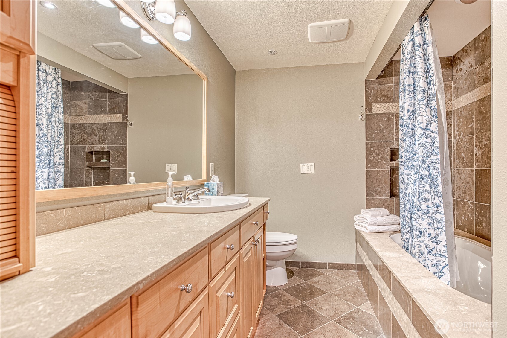 423 Lombard Lane Wenatchee, WA 98801 - Photo 21 of 36 a spacious bathroom with a granite countertop sink a toilet a mirror and shower