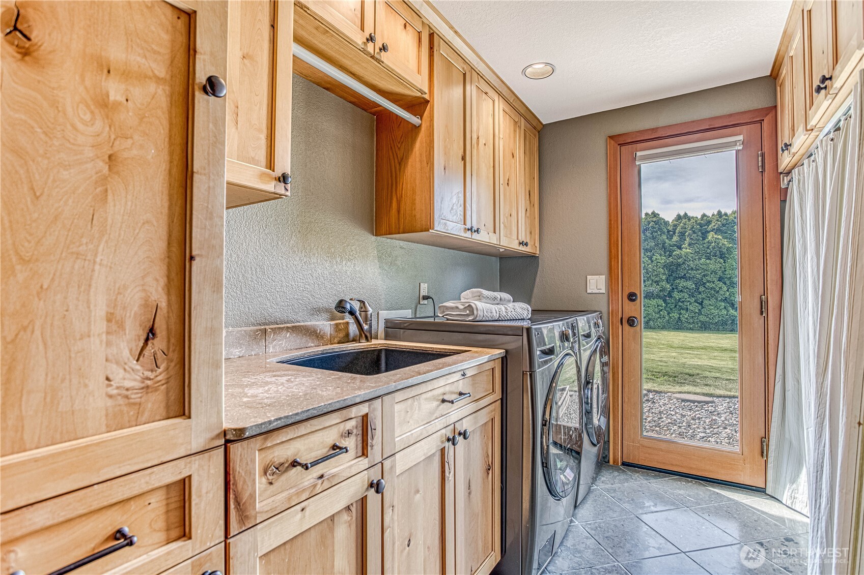 423 Lombard Lane Wenatchee, WA 98801 - Photo 23 of 36 a kitchen with a sink and cabinets