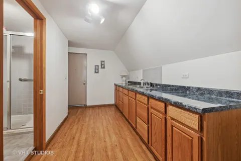 a view of a kitchen with wooden floor