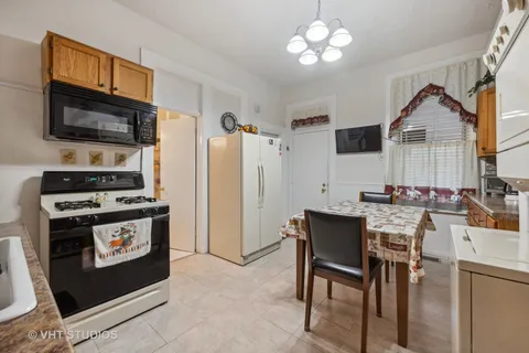a view of kitchen with furniture stove and refrigerator