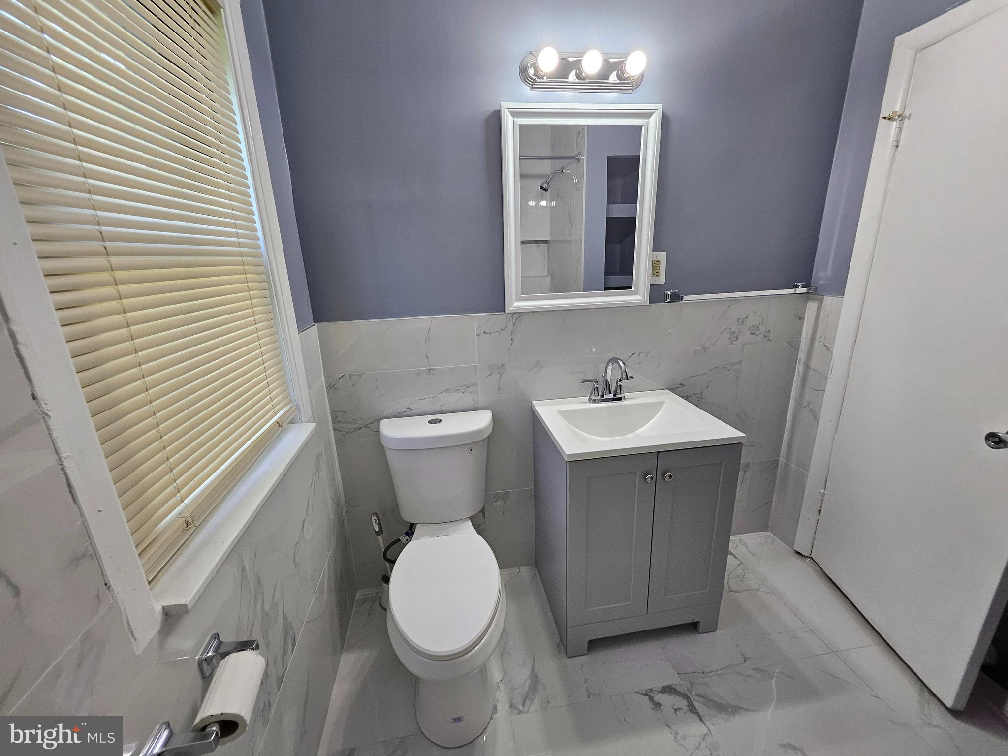 3401 15th Street Southeast Washington, DC 20032 - Photo 8 of 10 a bathroom with a sink toilet and mirror