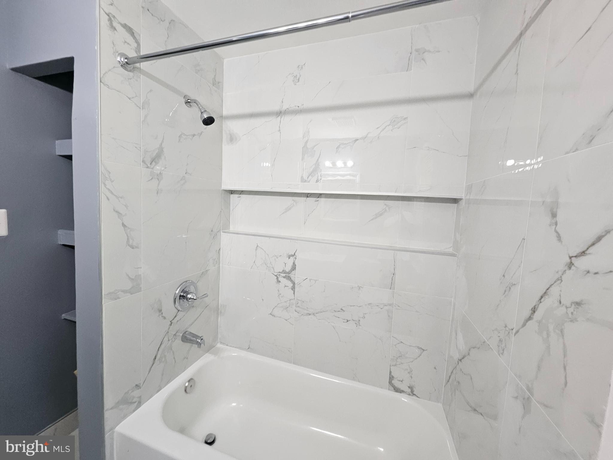 3401 15th Street Southeast Washington, DC 20032 - Photo 9 of 10 a bathroom with a bathtub and a shower
