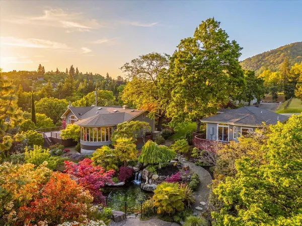 an aerial view of a house with yard swimming pool and outdoor seating
