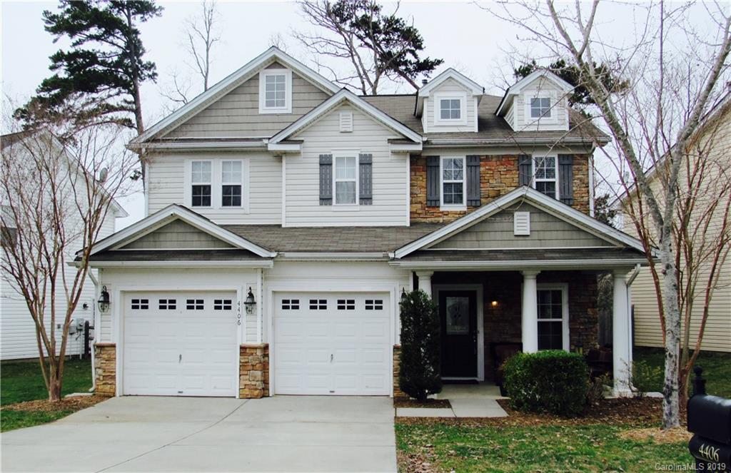 a view of a house with a yard and large trees