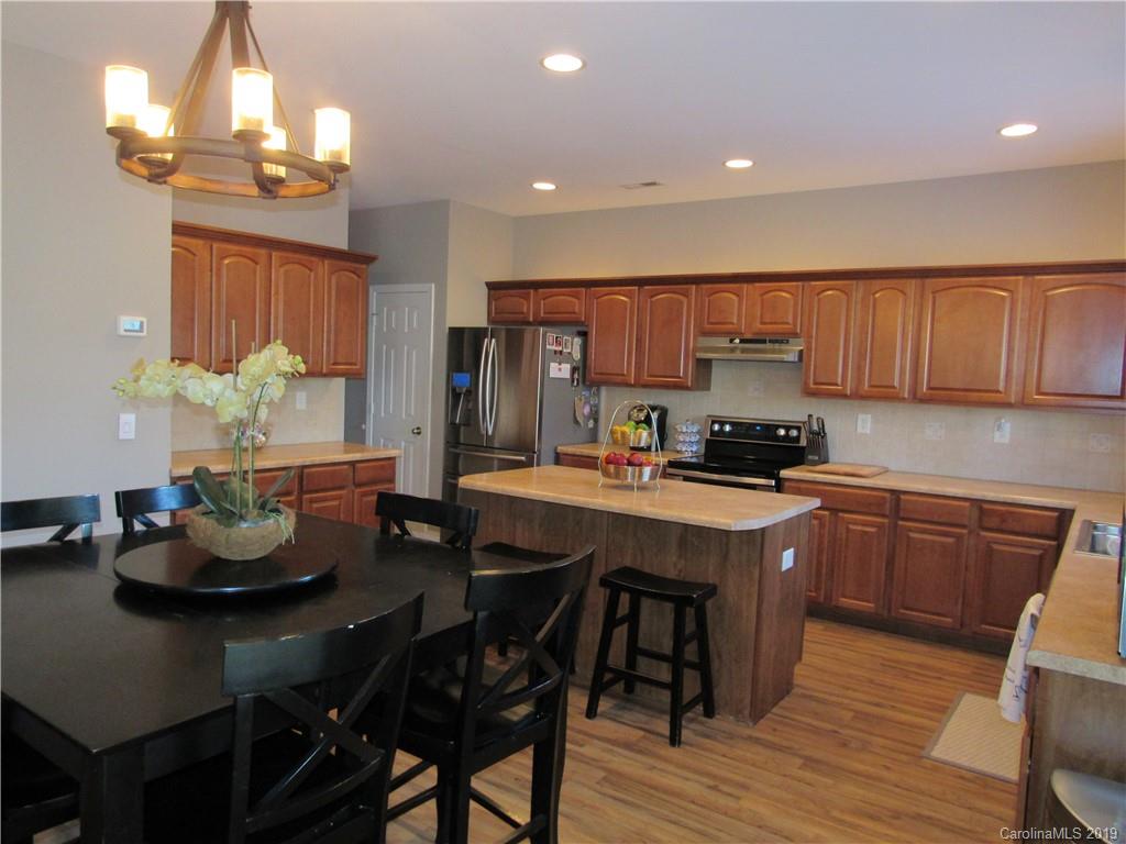 4406 Red Hook Road Monroe, NC 28110 - Photo 6 of 15 a kitchen with a dining table cabinets and appliances