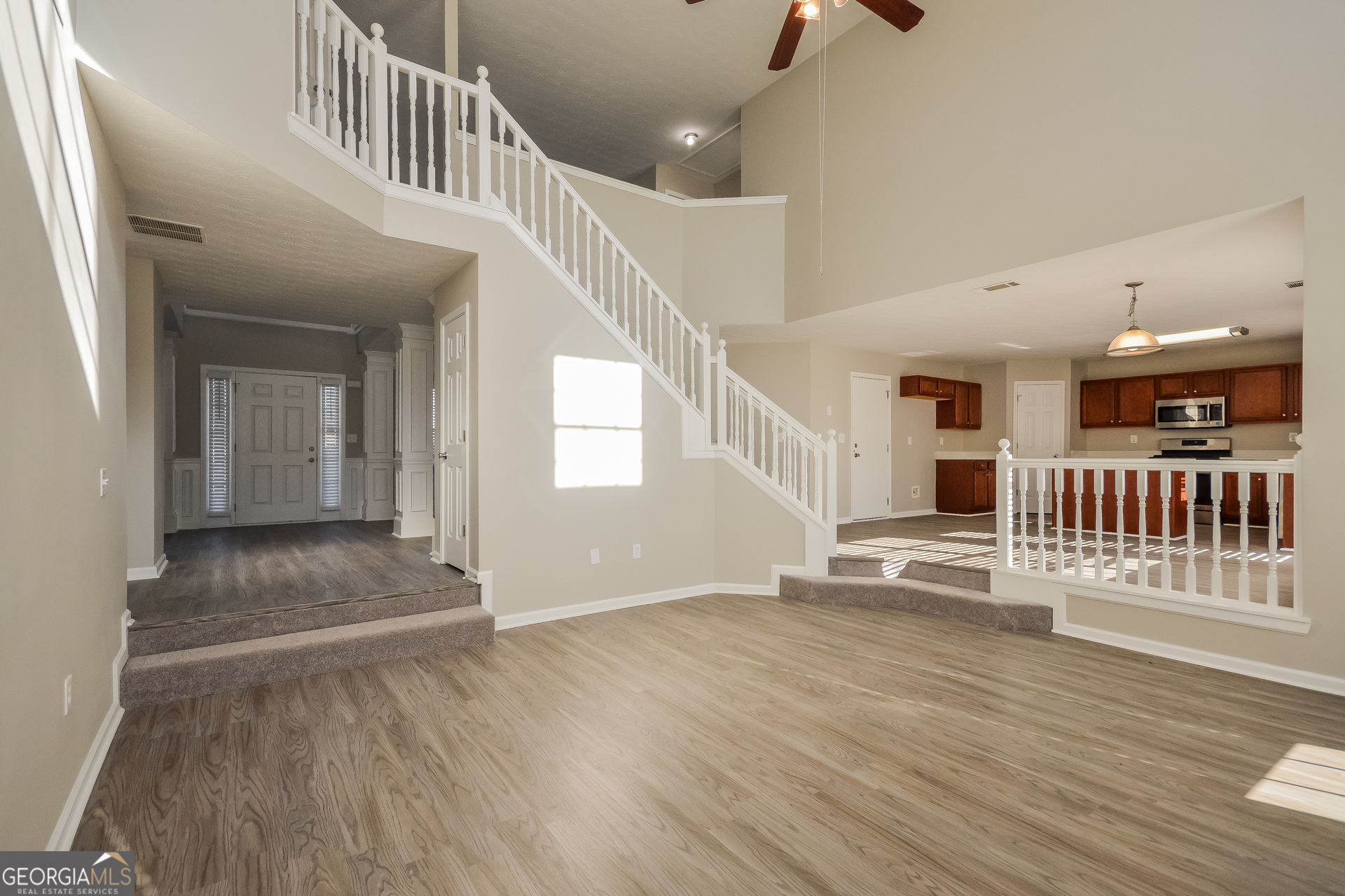 90 Emerson Trail Covington, GA 30016 - Photo 3 of 17 a view of a hallway with wooden floor and windows