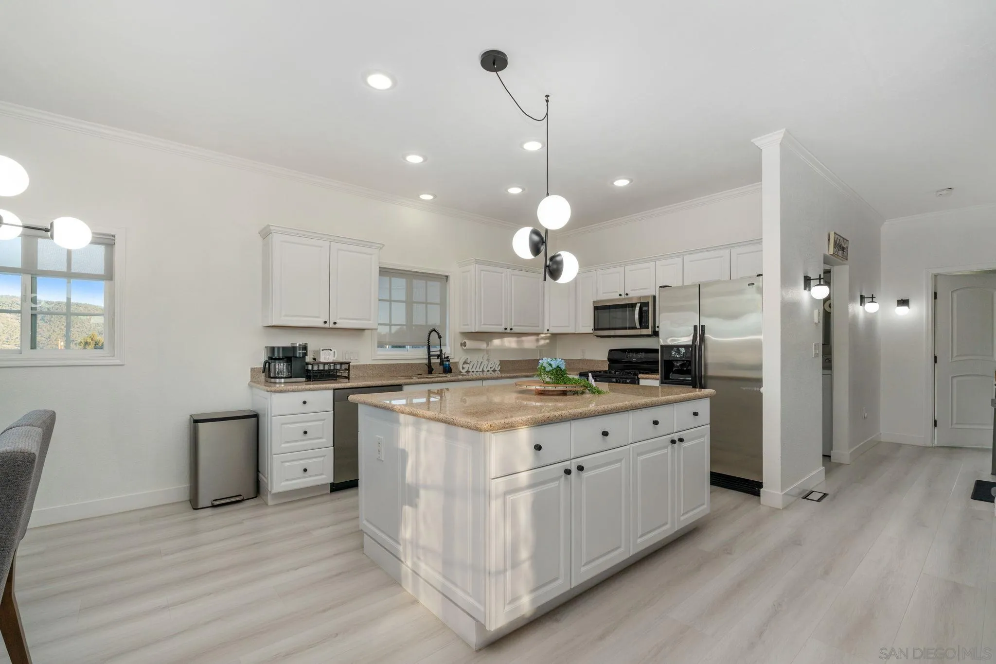 1842 Baldwin Lake Road Big Bear City, CA 92314 - Photo 13 of 40 a kitchen with white cabinets and stainless steel appliances