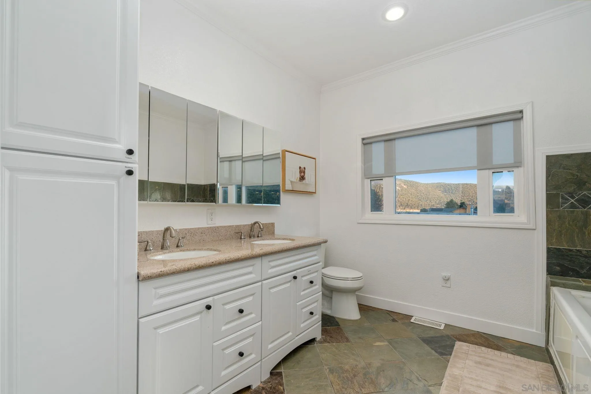 1842 Baldwin Lake Road Big Bear City, CA 92314 - Photo 26 of 40 a bathroom with a toilet sink and mirror