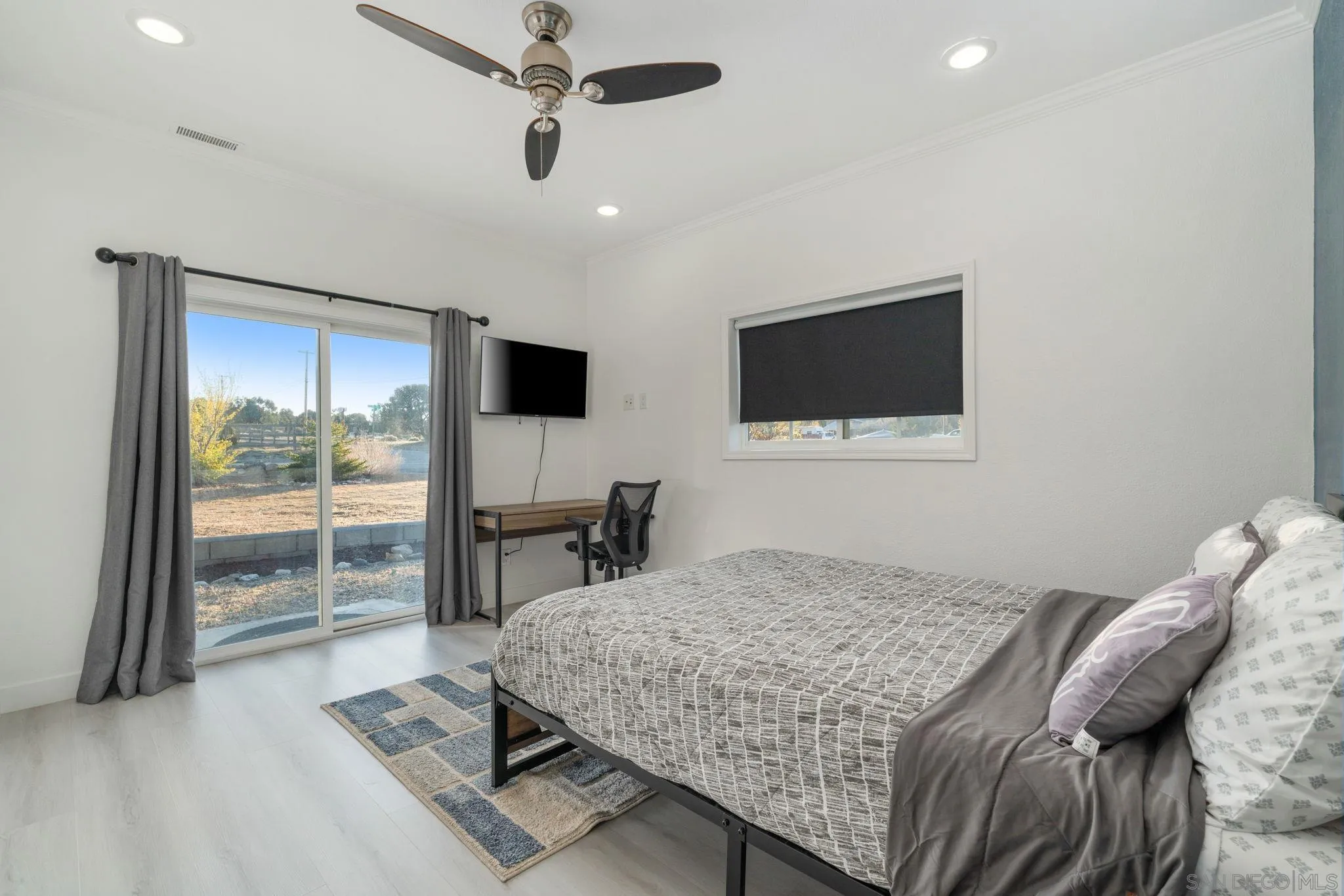 1842 Baldwin Lake Road Big Bear City, CA 92314 - Photo 6 of 40 a bedroom with a bed and glass door