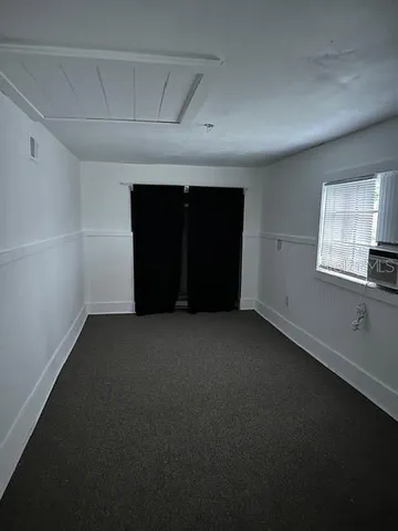 a view of an empty room and a window