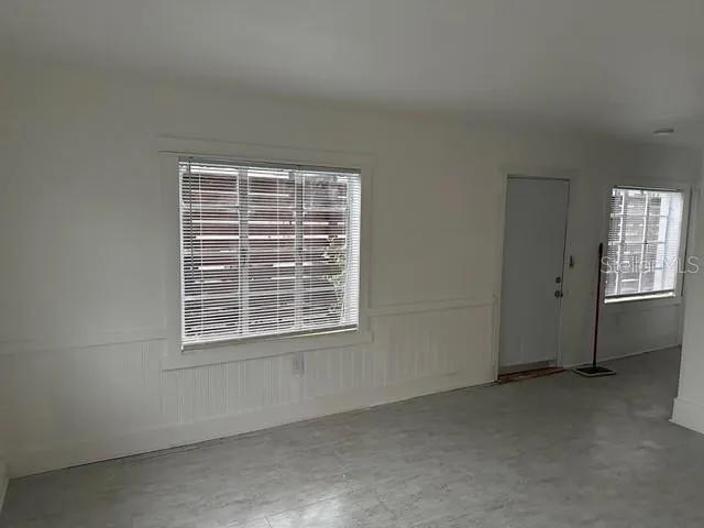 a view of an empty room with a window