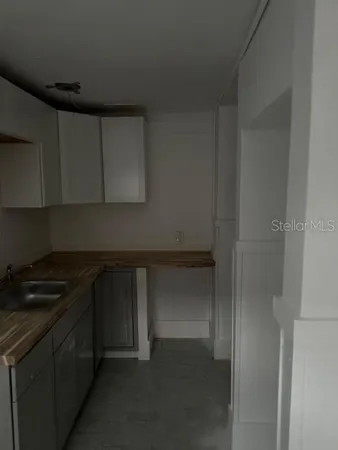 a kitchen with a sink and cabinets