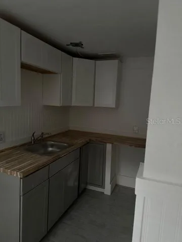 a kitchen with a sink and cabinets
