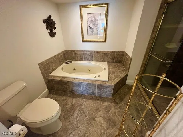 a bathroom with a tub and a shower
