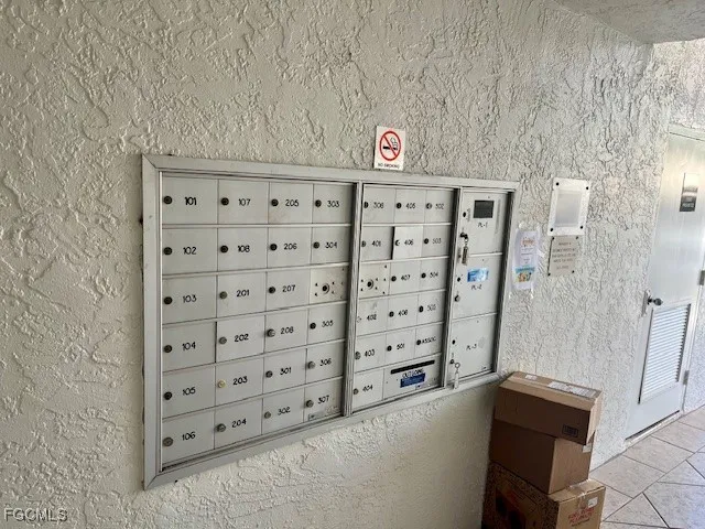 a view of a hallway with furniture and wooden floor