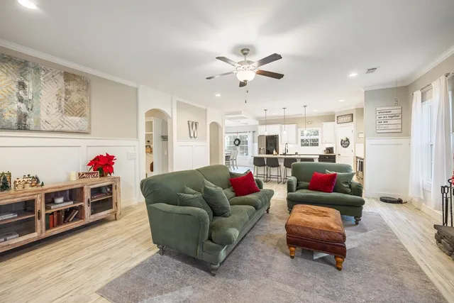 a living room with furniture a flat screen tv and a fireplace