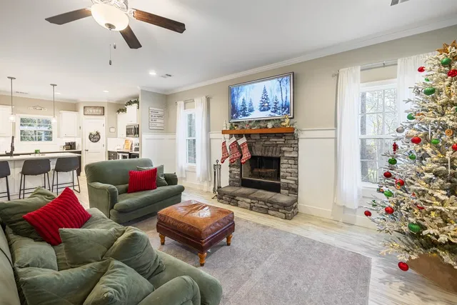a living room kitchen with furniture and a large window