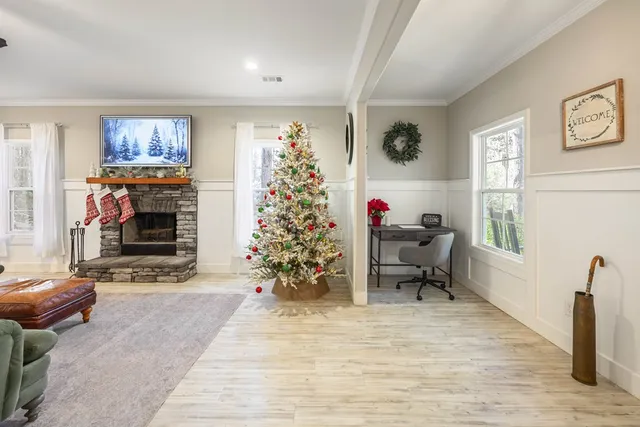 a living room with furniture flowers and a living room