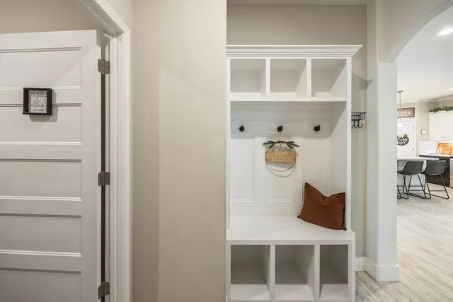 a bed sitting in a room next to a window