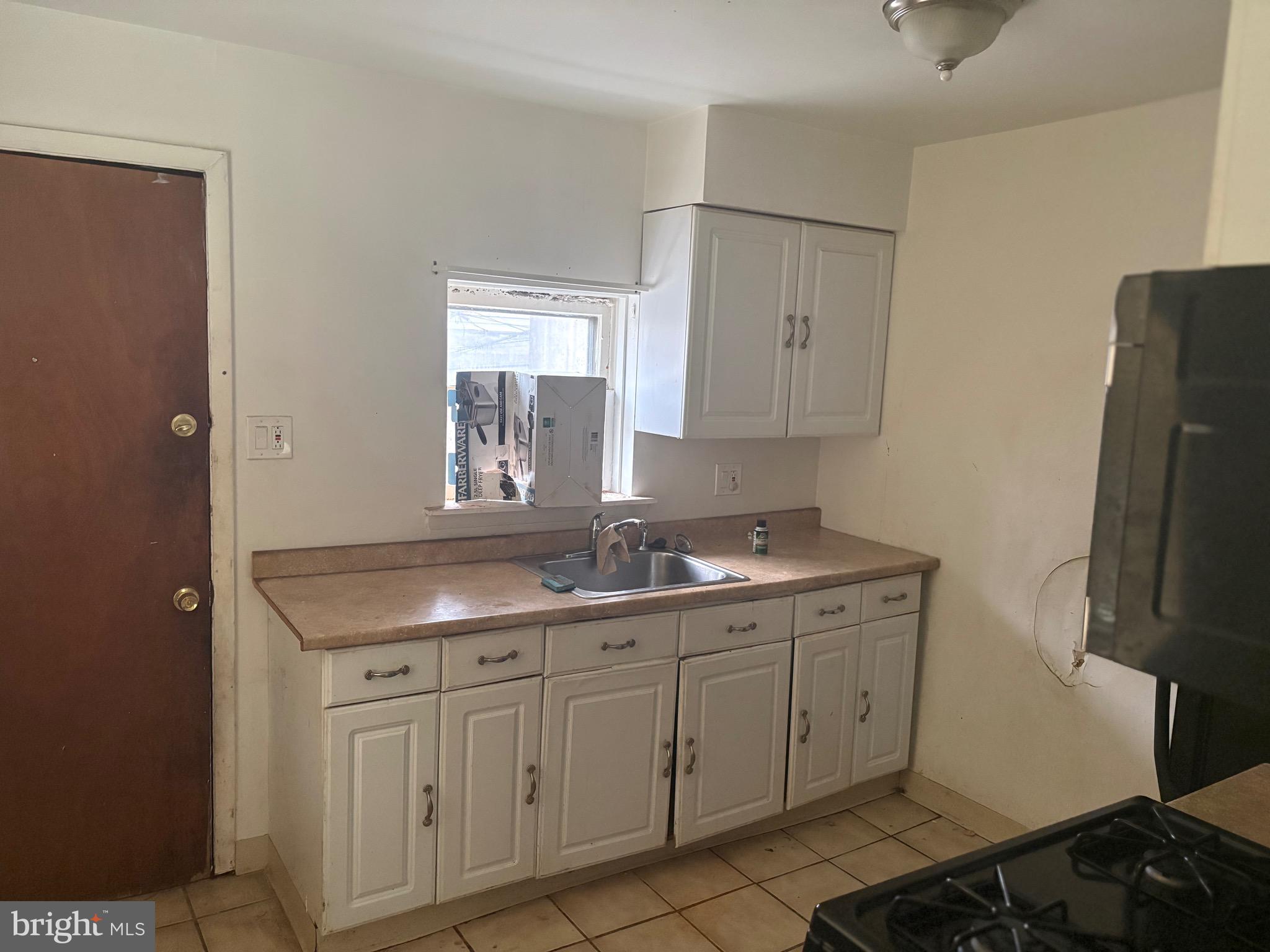 4437 North 19th Street Philadelphia, PA 19140 - Photo 4 of 16 a bathroom with a granite countertop sink and a mirror