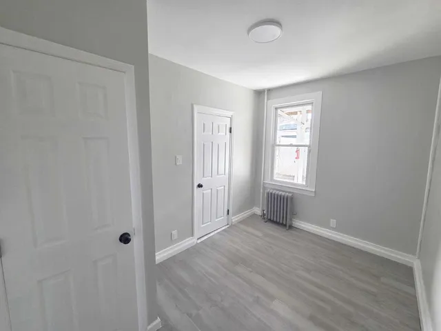 a kitchen with white cabinets a sink stove and refrigerator