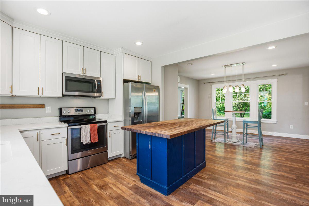 16146 Thomas Road Piney Point, MD 20674 - Photo 23 of 70 a kitchen with stainless steel appliances granite countertop a stove a refrigerator and a microwave