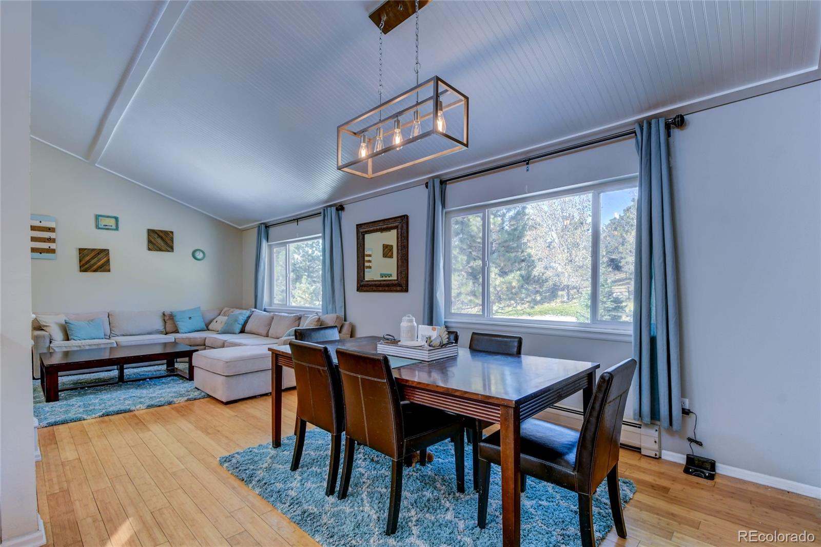 6359 Powell Road Parker, CO 80134 - Photo 11 of 38 a view of a dining room with furniture window and wooden floor