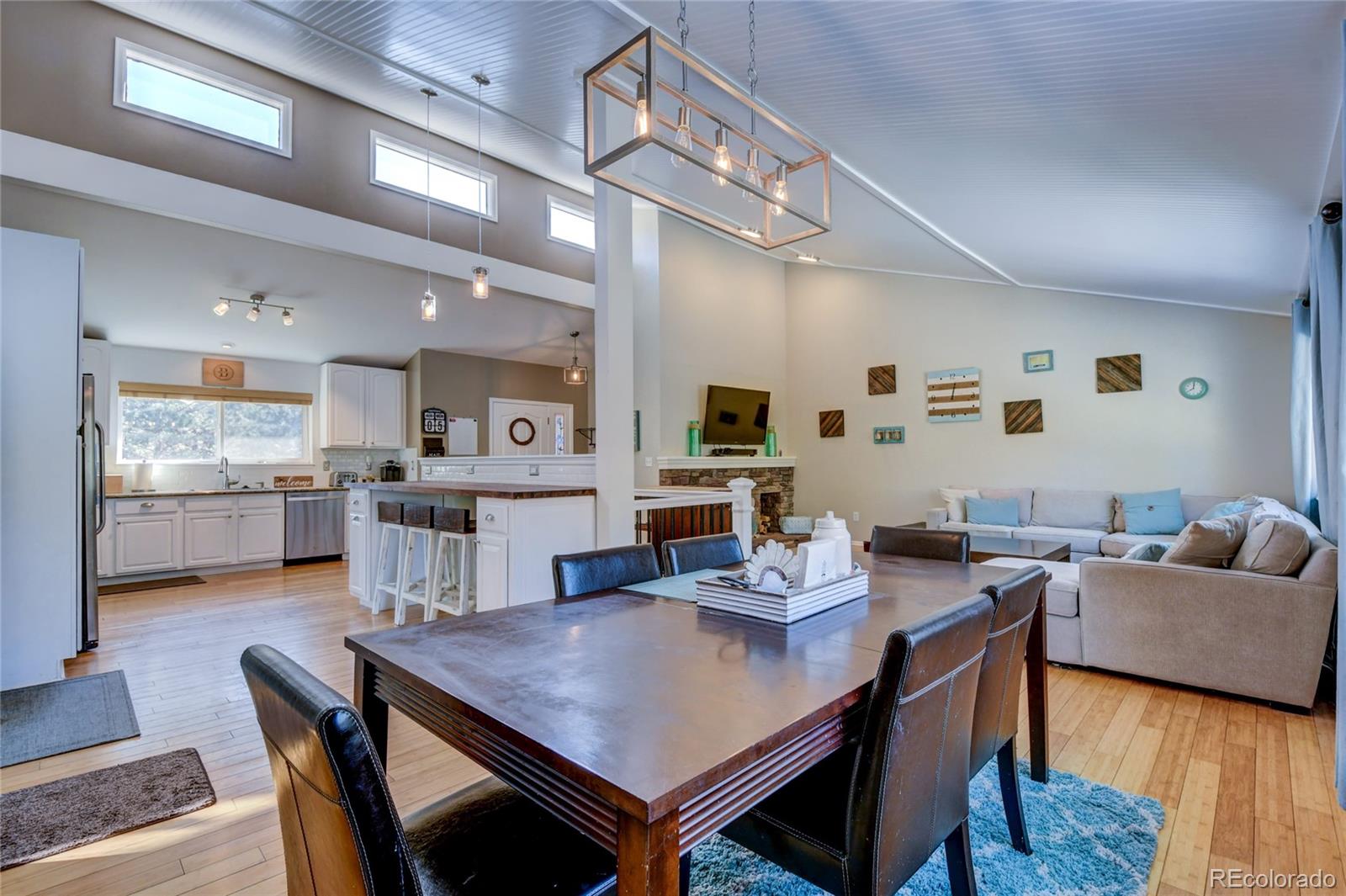 6359 Powell Road Parker, CO 80134 - Photo 12 of 38 a view of a dining room with furniture and wooden floor