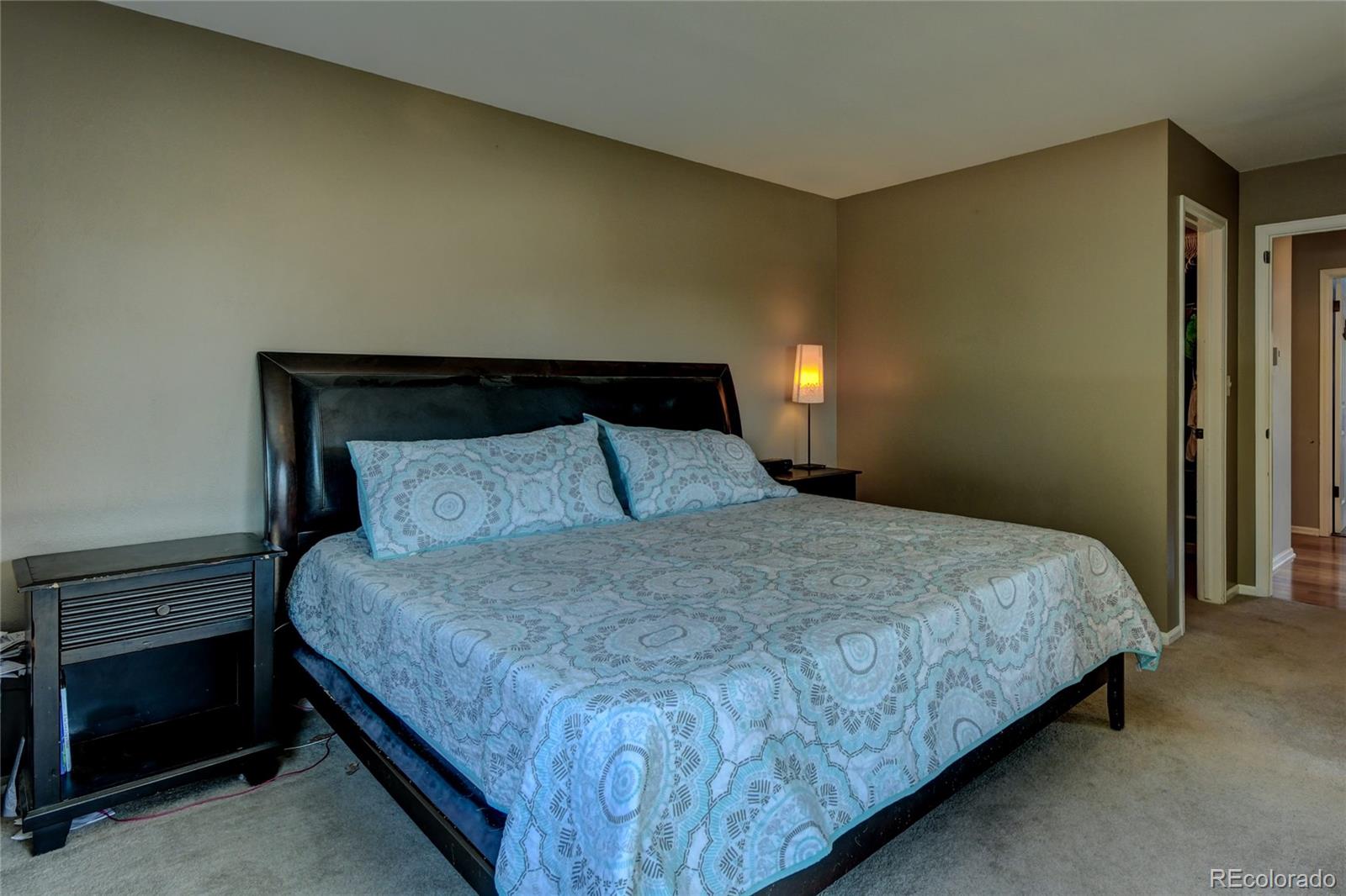 6359 Powell Road Parker, CO 80134 - Photo 18 of 38 a bedroom with a bed and a night stand