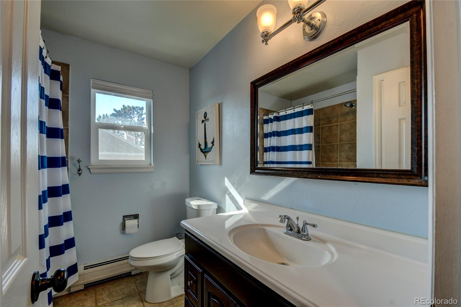 6359 Powell Road Parker, CO 80134 - Photo 24 of 38 a bathroom with a sink and a toilet
