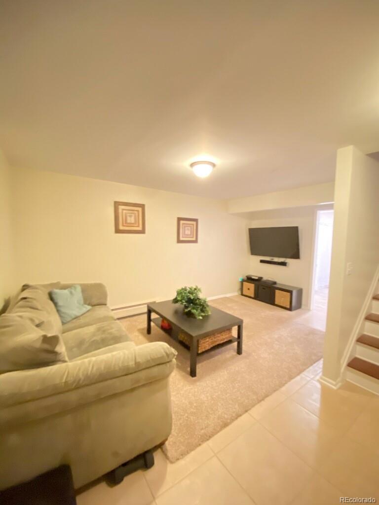 6359 Powell Road Parker, CO 80134 - Photo 26 of 38 a living room with furniture and a flat screen tv