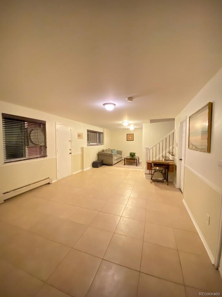 6359 Powell Road Parker, CO 80134 - Photo 27 of 38 a view of a livingroom with furniture and a refrigerator